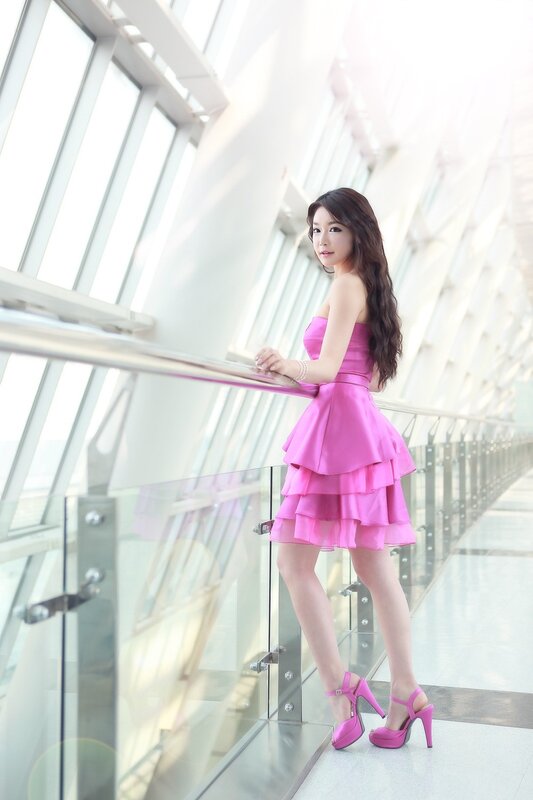 Woman in pink dress on balcony