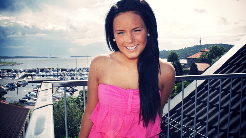 Woman in pink dress on balcony