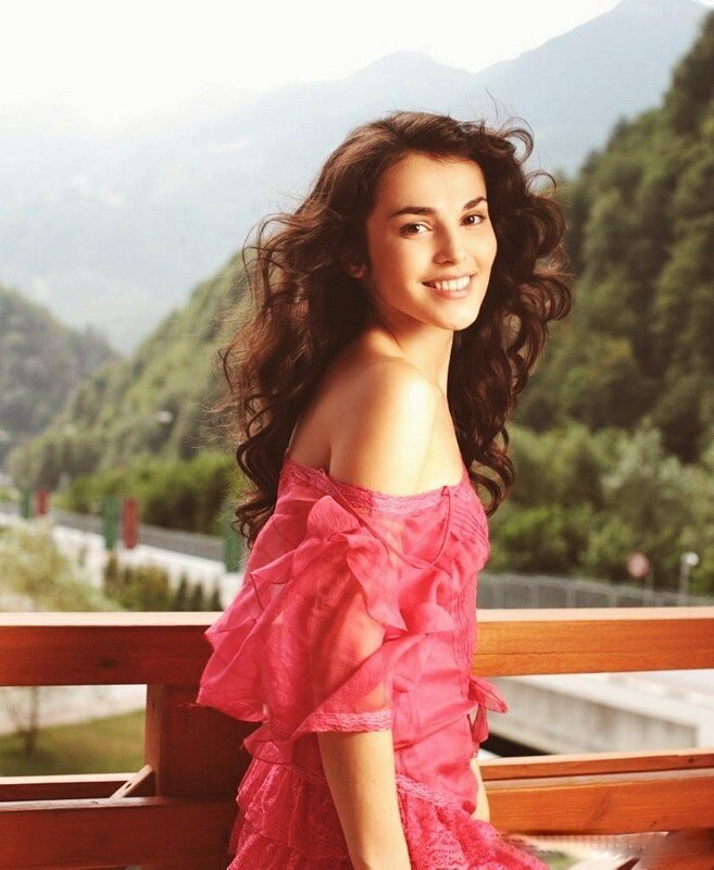 Woman in pink dress on balcony