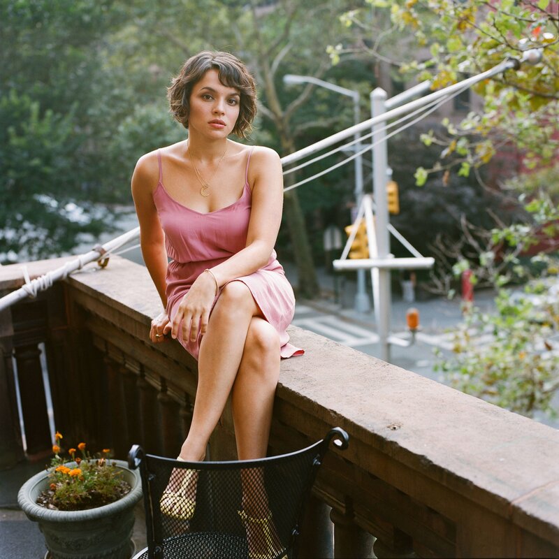 woman in pink dress on balcony