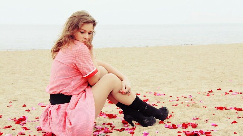 Woman in pink dress on beach