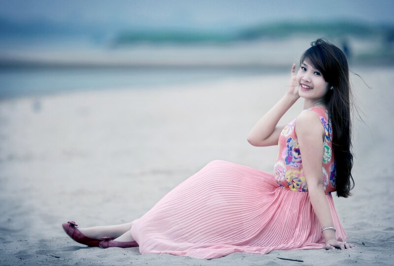 Woman in pink dress on beach