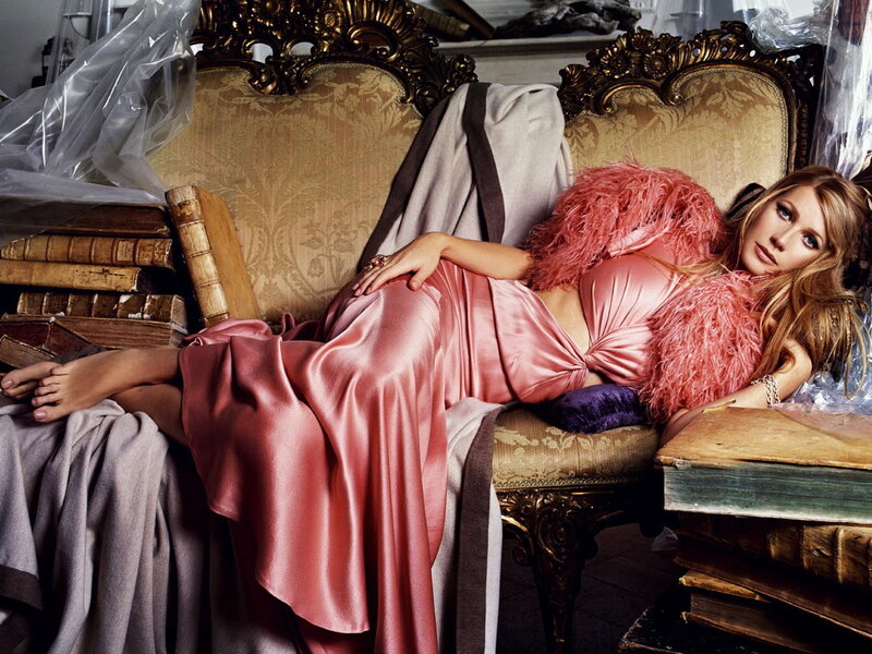 Woman in pink dress on ornate couch