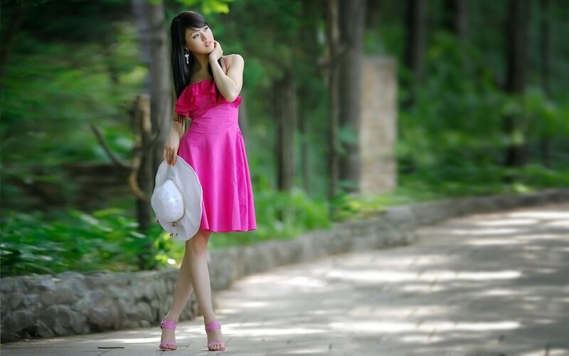 Woman in pink dress on path