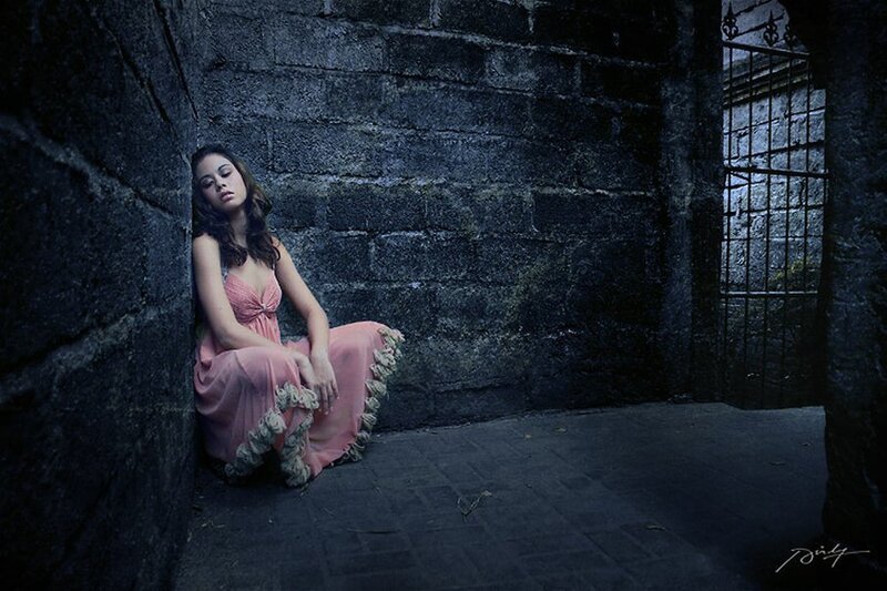 woman in pink dress sitting in dungeon