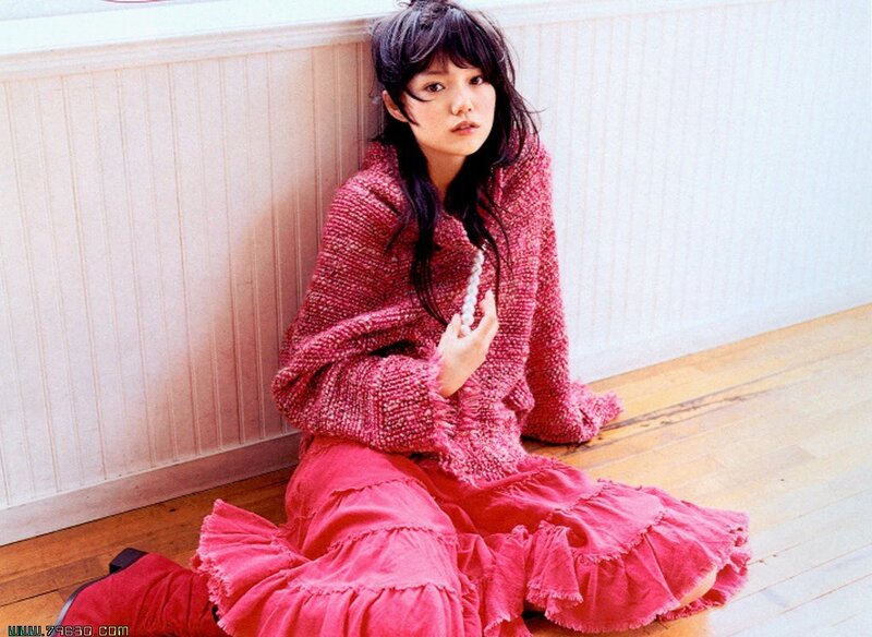 Woman in pink dress sitting on floor