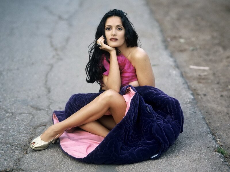 woman in pink dress sitting on road