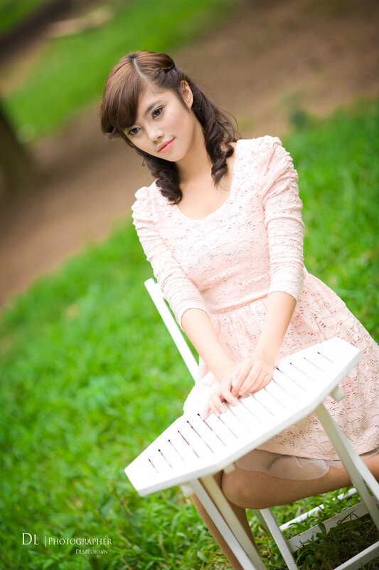 woman in pink dress sitting outdoors