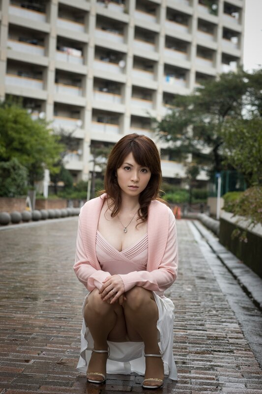 Woman in pink dress sitting outside