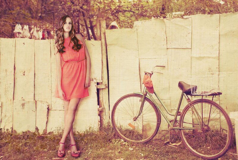 woman in pink dress with bicycle