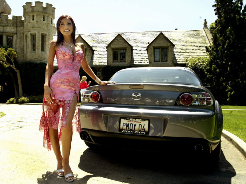 Woman in pink dress with car
