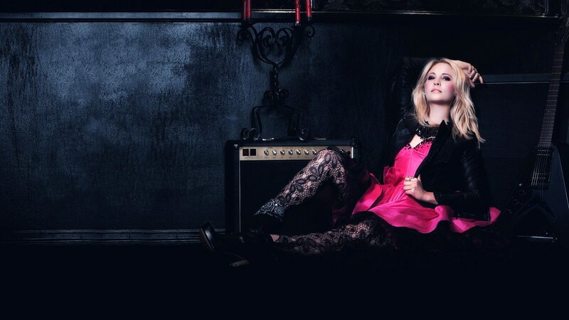 woman in pink dress with guitar