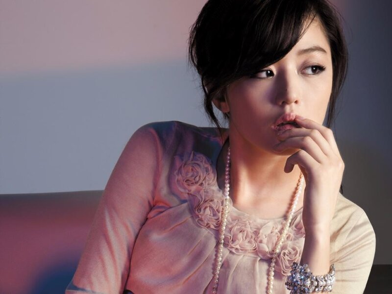 woman in pink dress with pearls
