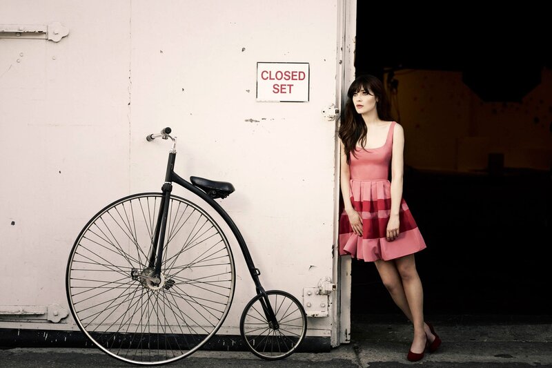 Woman in pink dress with penny-farthing