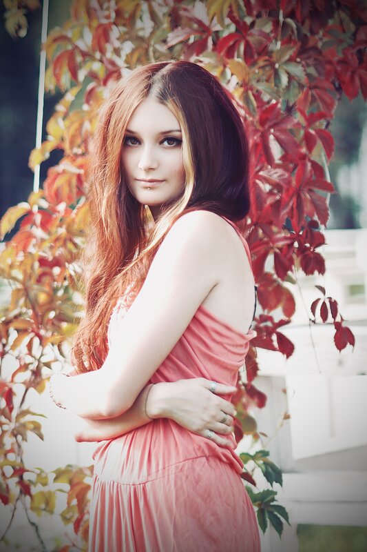 woman in pink dress with red leaves