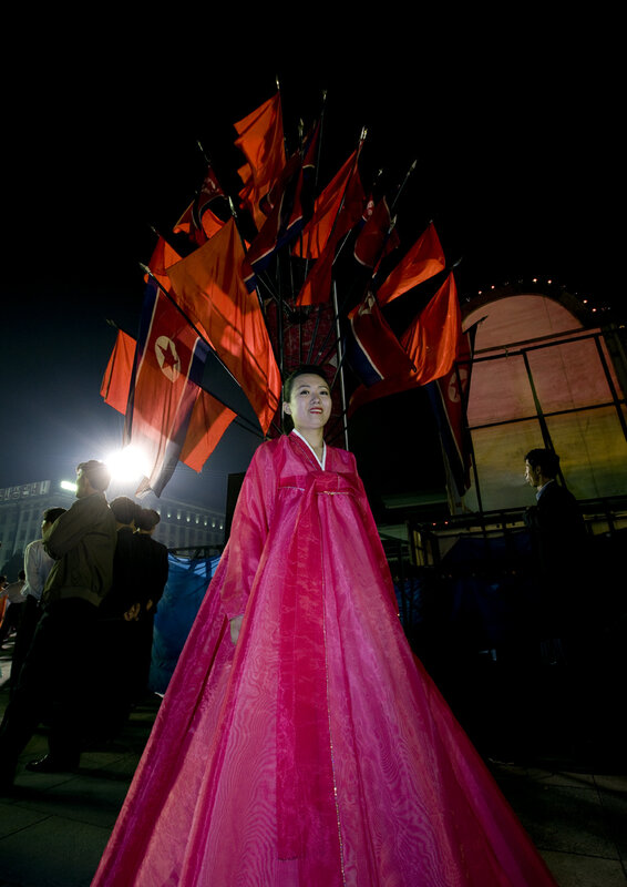 Woman in pink hanbok at night