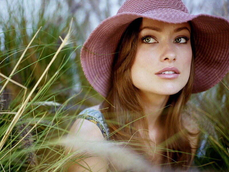 woman in pink hat among grass