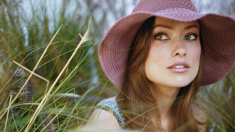woman in pink hat among grass