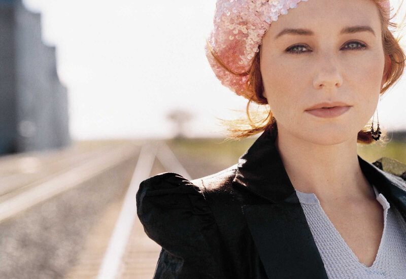 woman in pink hat by train tracks