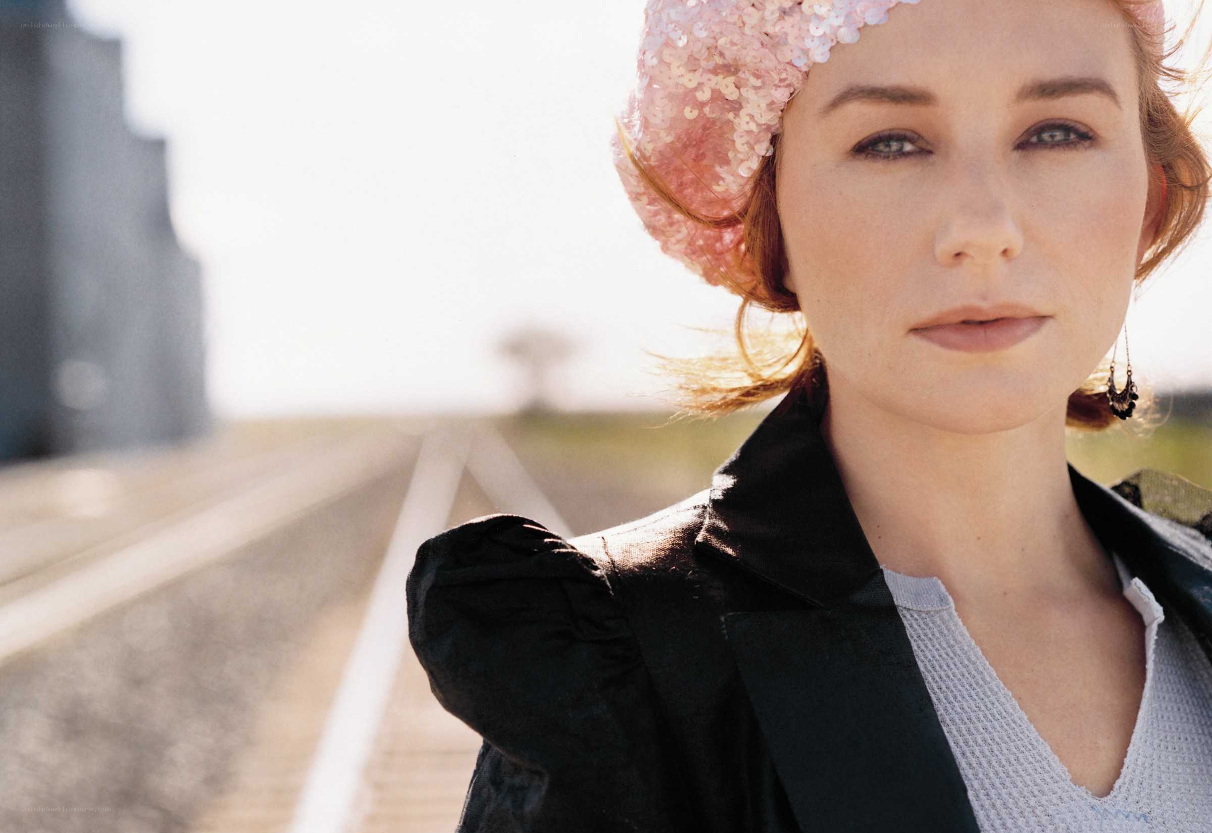 woman in pink hat by train tracks