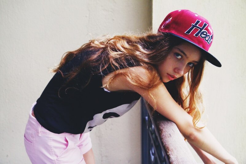 woman in pink hat leaning