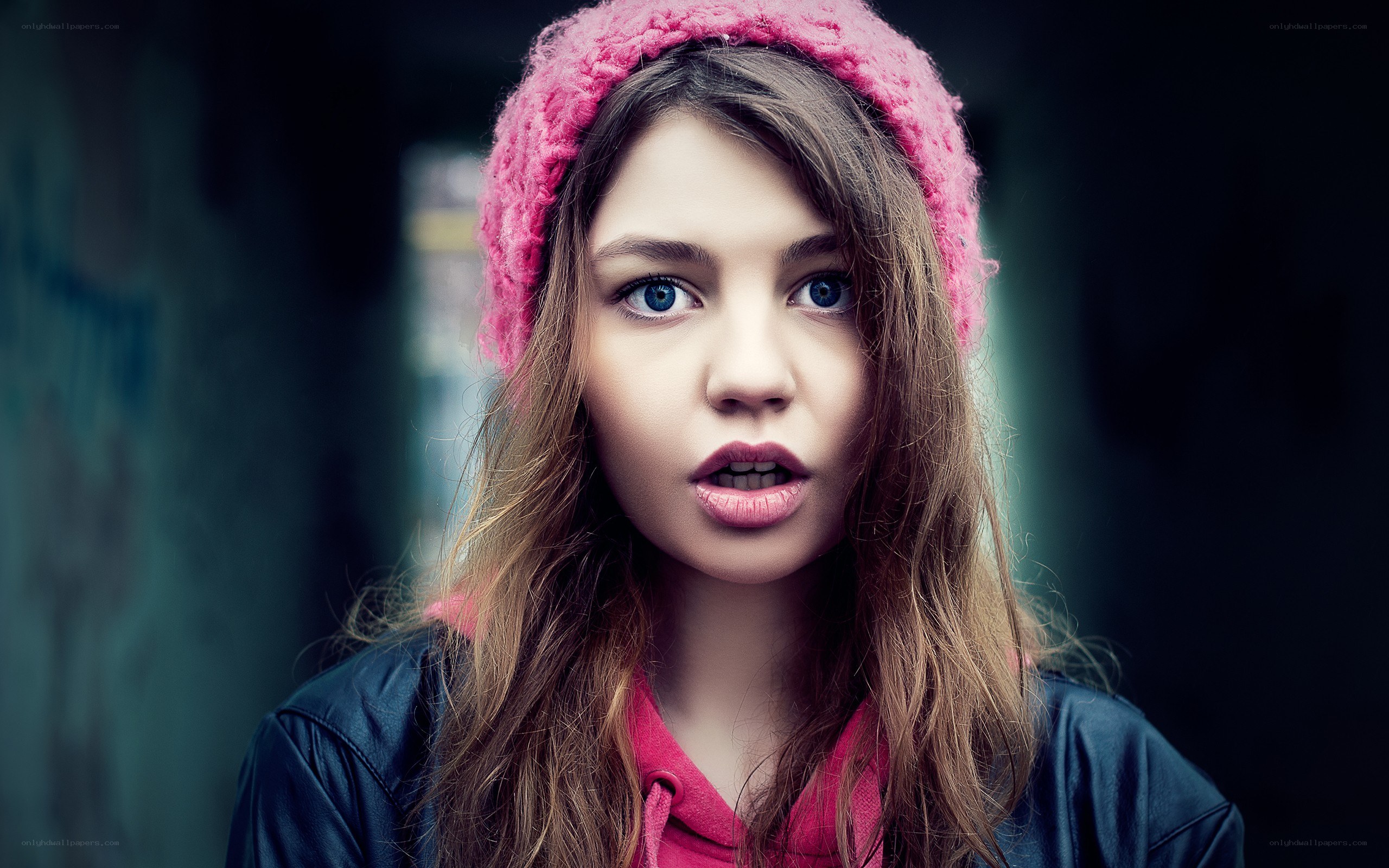 woman in pink hat looking surprised