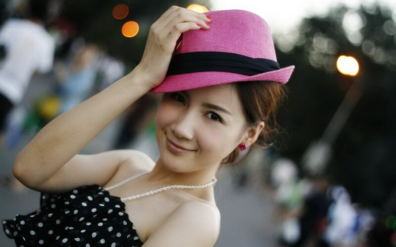 woman in pink hat smiling