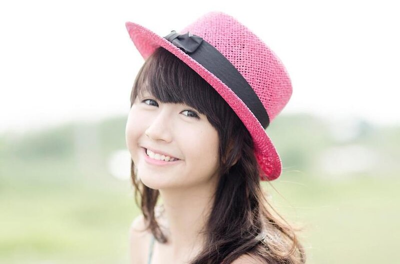woman in pink hat smiling