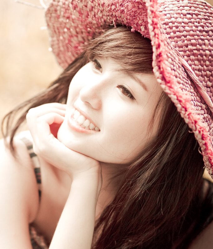 woman in pink hat smiling
