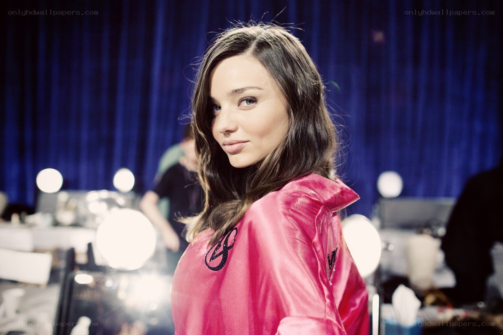 woman in pink jacket backstage