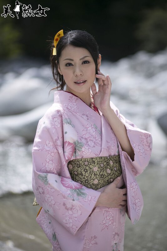 Woman in pink kimono by river