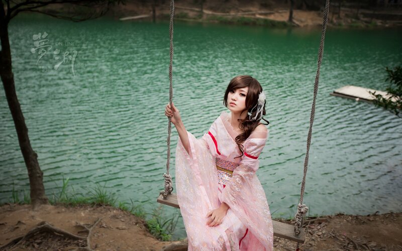 Woman in pink kimono on swing