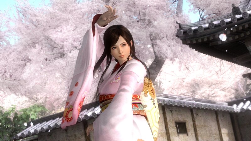 woman in pink kimono under cherry blossoms