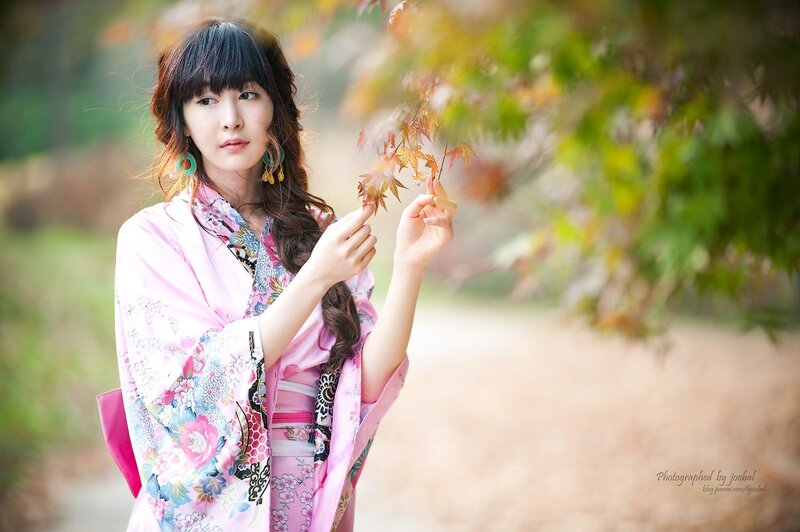 woman in pink kimono with autumn leaves