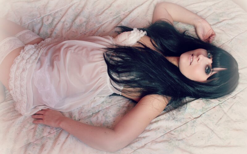woman in pink lingerie lying on bed