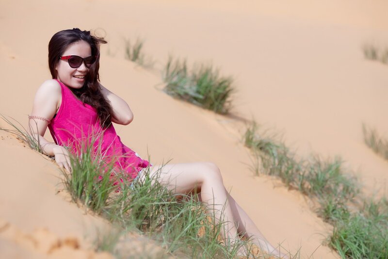 Woman in pink on a sand dune