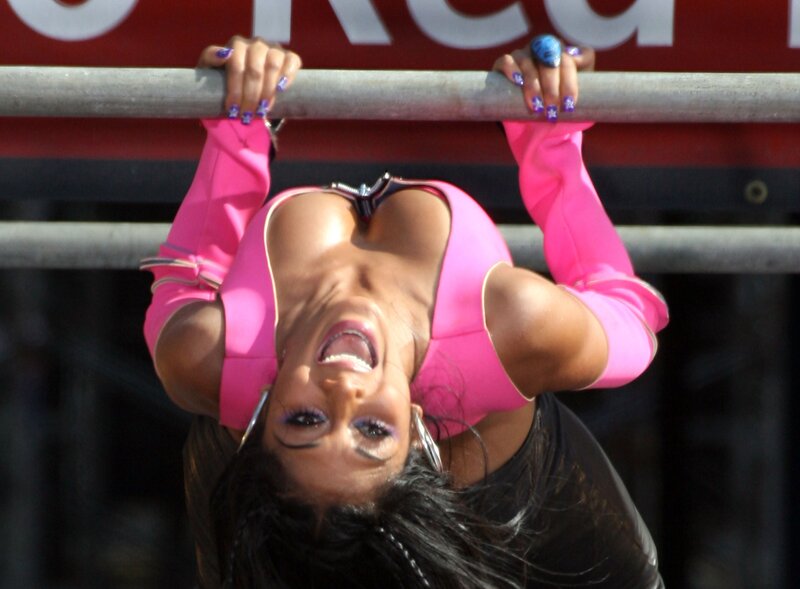 Woman in pink outfit hanging upside down