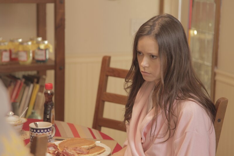 woman in pink robe at breakfast