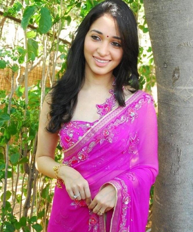 Woman in pink saree smiling