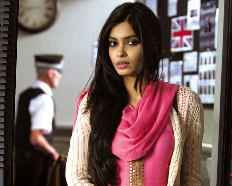 woman in pink scarf looking at camera