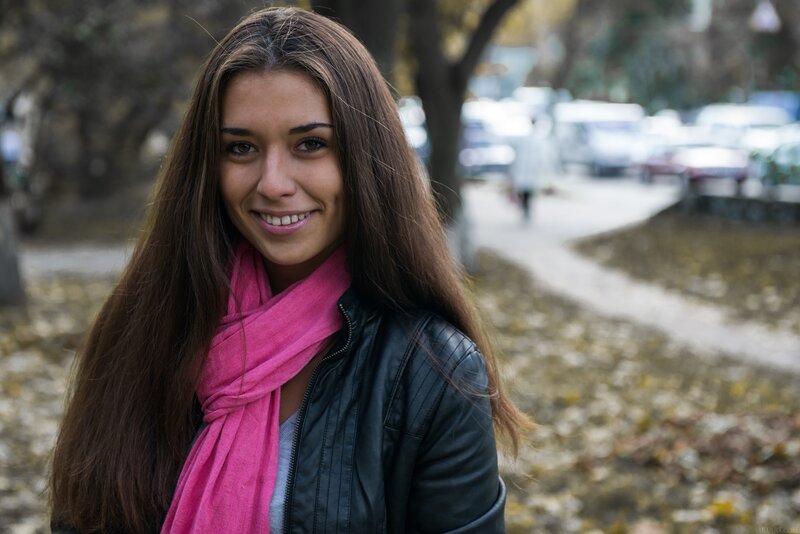 woman in pink scarf smiling