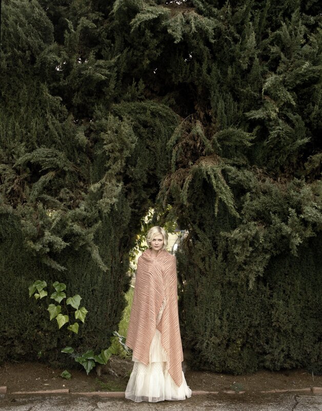 woman in pink shawl outdoors
