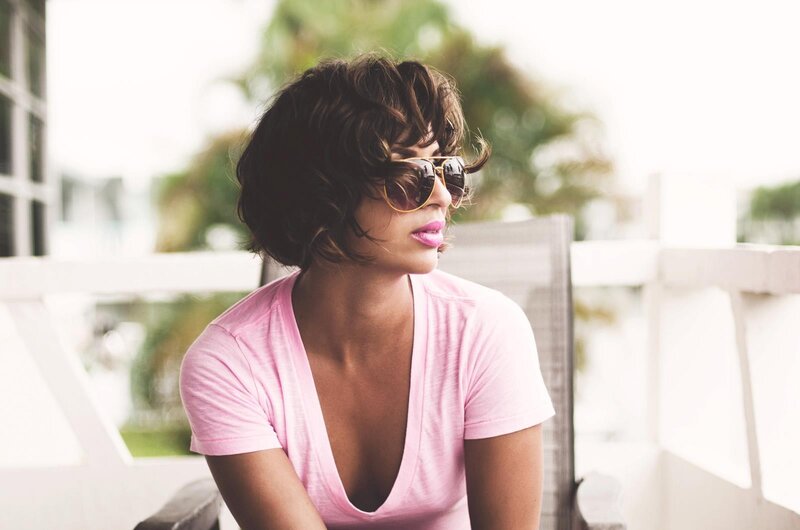woman in pink shirt and sunglasses