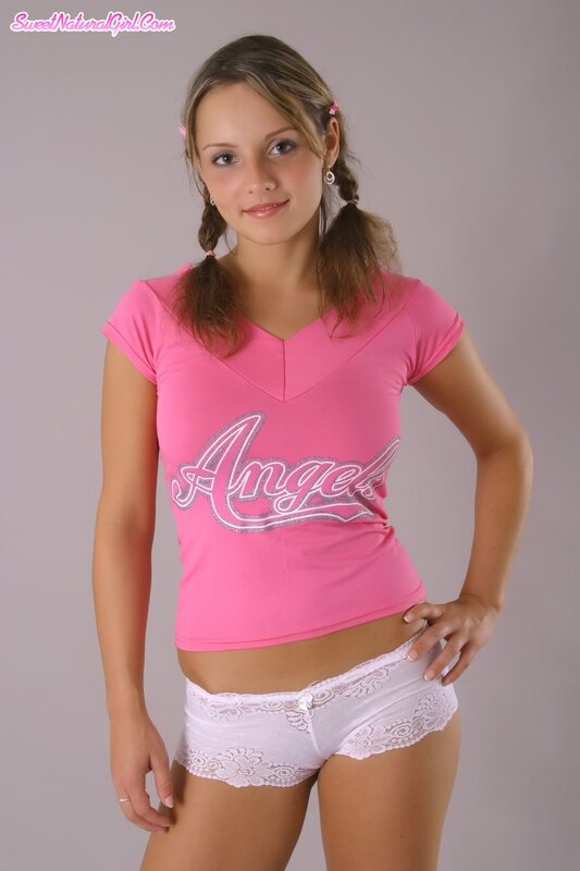 Woman in pink shirt and white shorts