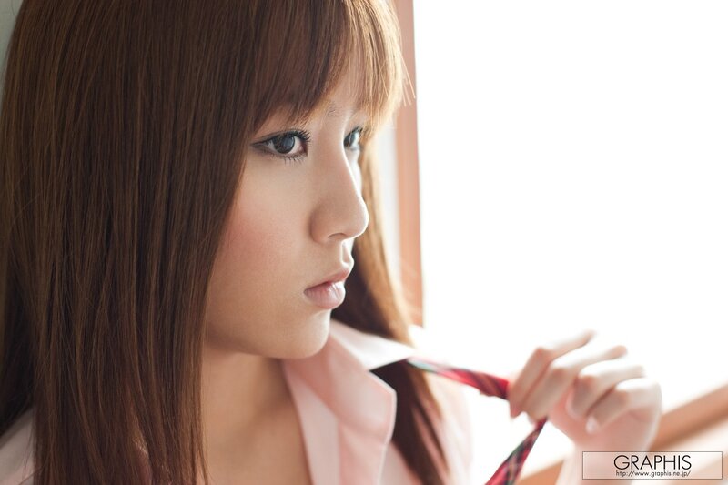 woman in pink shirt by window