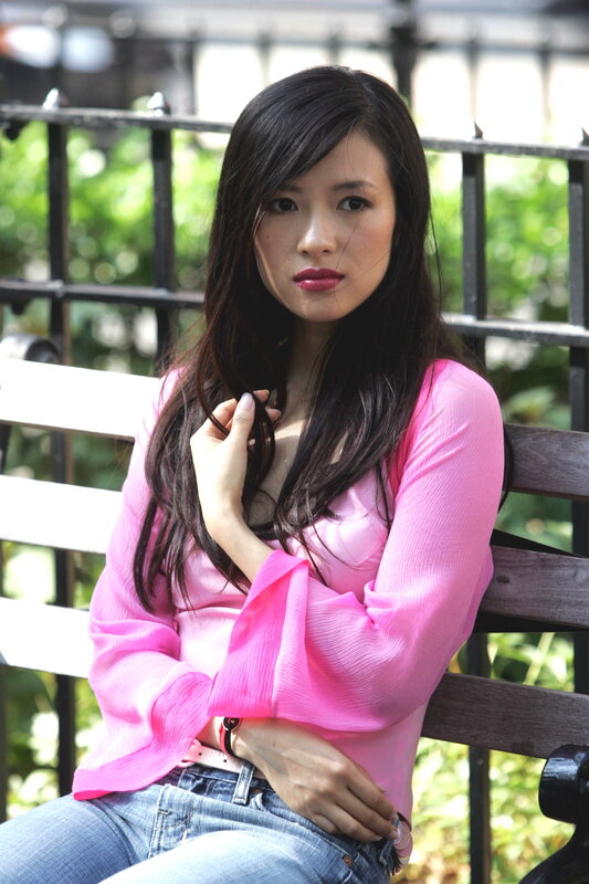 woman in pink shirt on bench