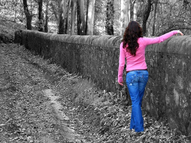 Woman in pink shirt on forest path
