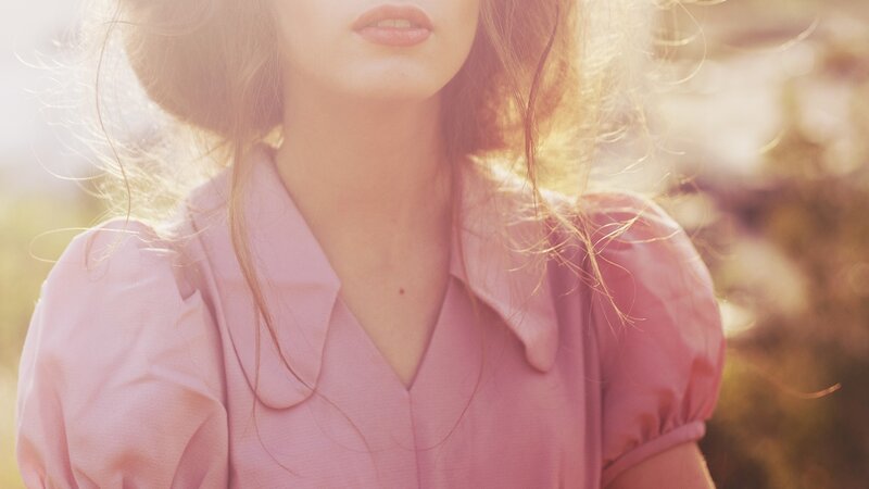 woman in pink shirt with sunlight