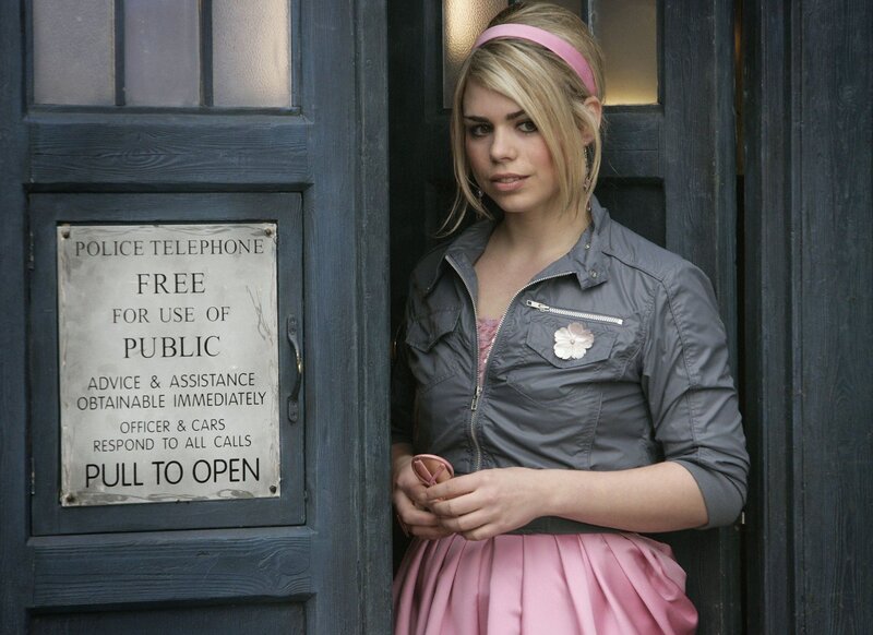 Woman in pink skirt by phone booth