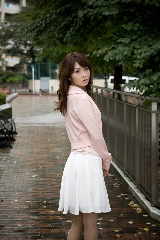 Woman in pink sweater and white skirt